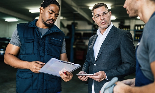 three men checking an inventory