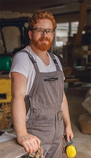 man wearing an apron posing and smiling